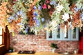 Cozy room decorated with summer floral decor. Interior Kitchen with Composition colorful wildflowers and plant hanging on wall.