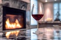 Romantic fire in the fireplace and a glass of red wine. Royalty Free Stock Photo