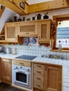 Cozy Rustic Kitchen Interior with Wooden Cabinets Royalty Free Stock Photo