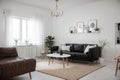 Cozy Scandinavian home living room with kitchen interior design with empty mockup space on white wall. couch, dining table, and ho Royalty Free Stock Photo