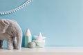 Cozy scandinavian newborn baby room with gray plush elephant, white stars lamp and children accessories.