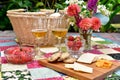 Romantic patio setting for relaxing warm summer evening outdoor picnic in beautifully landscaped garden Royalty Free Stock Photo