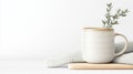 This cozy setup features a white ceramic mug with olive leaves placed on a textured knitted cloth, creating a calm and Royalty Free Stock Photo