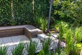 Cozy shady seating area made of concrete and wood in a garden Royalty Free Stock Photo