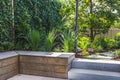 Cozy shady seating area made of concrete and wood in a garden Royalty Free Stock Photo