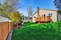 Cozy small backyard with wooden walkout deck Royalty Free Stock Photo