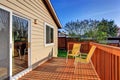 Cozy small backyard with wooden walkout deck Royalty Free Stock Photo