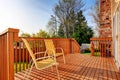 Cozy small backyard with wooden walkout deck Royalty Free Stock Photo