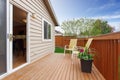 Cozy small backyard with wooden walkout deck Royalty Free Stock Photo