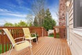 Cozy small backyard with wooden walkout deck Royalty Free Stock Photo