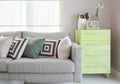 Cozy sofa with geometric pattern pillows and green sideboard Royalty Free Stock Photo