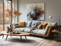Cozy sofa with grey cushions and orange pillows against floor to ceiling window. Scandinavian interior design of modern stylish Royalty Free Stock Photo