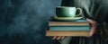 The cozy stack of books with a green cup and saucer on top..AI generated image Royalty Free Stock Photo