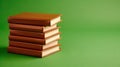 A cozy stack of brown hardbacks sits elegantly on a soft green backdrop, perfect for book lovers and aesthetic enthusiasts Royalty Free Stock Photo