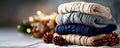 Cozy Stack of Knit Sweaters with Pinecones and Festive Lights in a Warm Winter Setting Royalty Free Stock Photo