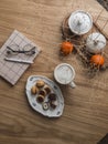 Cozy still life coffee break - coffee mug, sweets, diary, kitchen decor on a wooden round table top view Royalty Free Stock Photo