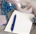 Cozy still life in grunge style monochrome grey shades and blue color, notepad, pen and Christmas decorations and warm knitted Royalty Free Stock Photo