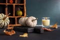 Cozy still life with small decorative pumpkins and aroma candle