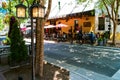 Cozy street cafe with customers and lights Royalty Free Stock Photo