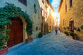 Cozy street decorated with colorful flowers, Pienza, Tuscany, Italy, Europe. Narrow street in the charming town of Pienza in