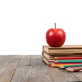 Cozy Study Scene with Red Apple on Stack of Books on Wooden Table Neutral Background Royalty Free Stock Photo