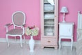 Cozy stylish vintage corner of the pink bedroom with floor vase