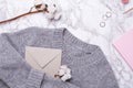 Cozy sweater with envelope , pink notebook and rings on marble background Royalty Free Stock Photo
