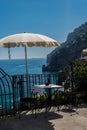 A cozy table in a cafe with a white tablecloth with a beautiful view of the city of Positano in Italy Royalty Free Stock Photo