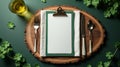Table setting with empty clipboard, cutlery, and beer, shamrocks. Blank menu for St Patrick's Day, mockup, copy Royalty Free Stock Photo