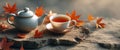Cozy tea setup featuring a teapot and cup on a textured surface with scattered leaves Royalty Free Stock Photo
