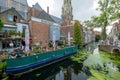 A cozy terrace on a boat in the canal, in the center of Delft, t
