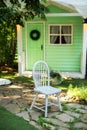 Cozy terrace in garden with wooden chair. Decor in summer patio for relax. Autumn front porch home. Exterior wooden porch home wit Royalty Free Stock Photo