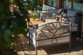 Cozy terrace with sofas for rest, Glass with champagne on a wooden table. Royalty Free Stock Photo