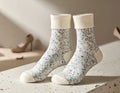 Cozy Warm Crew Socks with Speckled Pattern and Cream Cuffs on a Textured Surface Royalty Free Stock Photo