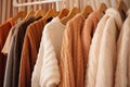 Cozy warm wardrobe, knitted cardigans hanging on a hanger in the closet Royalty Free Stock Photo
