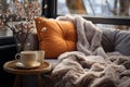 Cozy warm winter composition with soft pillows, cozy blanket and snowy landscape on winter day. Winter home decor. Christmas. New Royalty Free Stock Photo