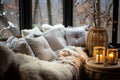 Cozy warm winter composition with soft pillows, cozy blanket and snowy landscape on winter day. Winter home decor. Christmas. New Royalty Free Stock Photo