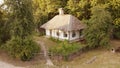 Cozy white house with casement windows in the vilage from above.