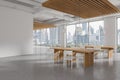 Cozy white office kitchen interior with wooden eating table and chairs, window