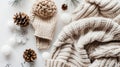 Cozy winter accessories arranged neatly, featuring a knit hat, sweater, and decorations