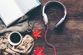 Cozy winter background, cup of hot coffee with marshmallow, book note, headphones and leaves maple relax on season autumn, warm kn Royalty Free Stock Photo