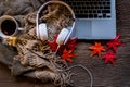 Cozy winter background, laptop with cup of hot coffee with marshmallow and headphone music, warm knitted sweater, relax and cozy Royalty Free Stock Photo