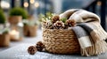 Cozy Winter Basket with Pine Cones and Blanket on Snow-Dusted Balcony Royalty Free Stock Photo
