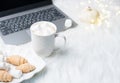 Cozy winter bloggers white work space with laptop, coffee with m