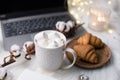 Cozy winter bloggers white work space with laptop, coffee with m