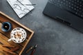 Cozy winter business flatlay arrangement with black laptop, wooden tray with vegan cocoa