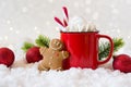 Cozy winter composition with a cup of hot chocolate with marshmallows gingerbread man cookies on a light background