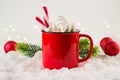 Cozy winter composition with a red cup of hot chocolate with marshmallows on a festive background Royalty Free Stock Photo