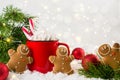 Cozy winter composition with a red cup of hot chocolate with marshmallows gingerbread man cookies on a festive background Royalty Free Stock Photo