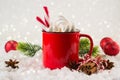 Cozy winter composition with a red cup of hot chocolate with marshmallows on a light background